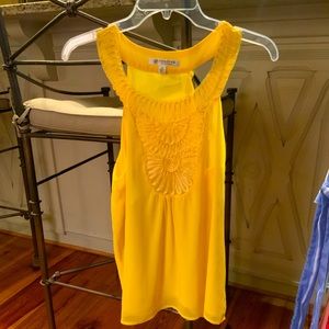 Sleeve-less yellow women’s blouse.